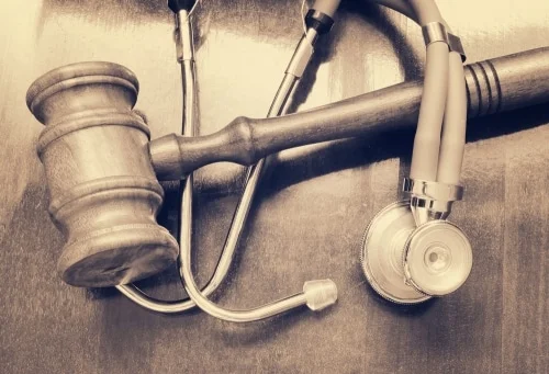 a gavel on a table with a stethoscope