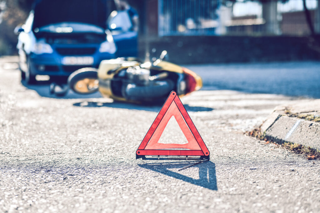 motorcycle accident scene marked with a triangle, potential motorcycle accident claim