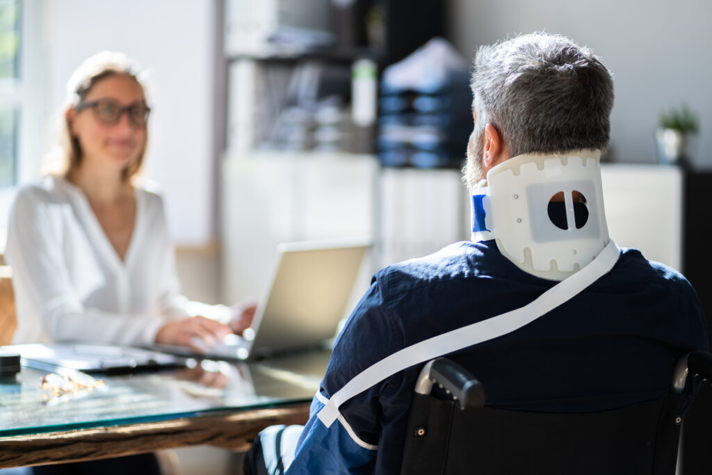 injured man meeting with a personal injury lawyer