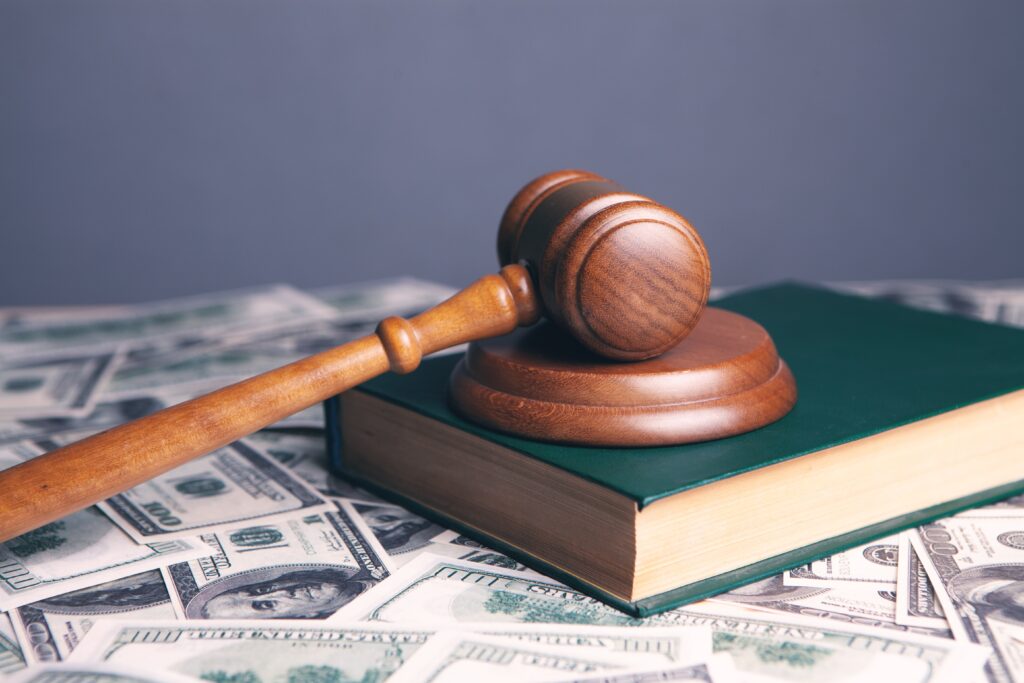 personal injury claim gavel on a bible on money