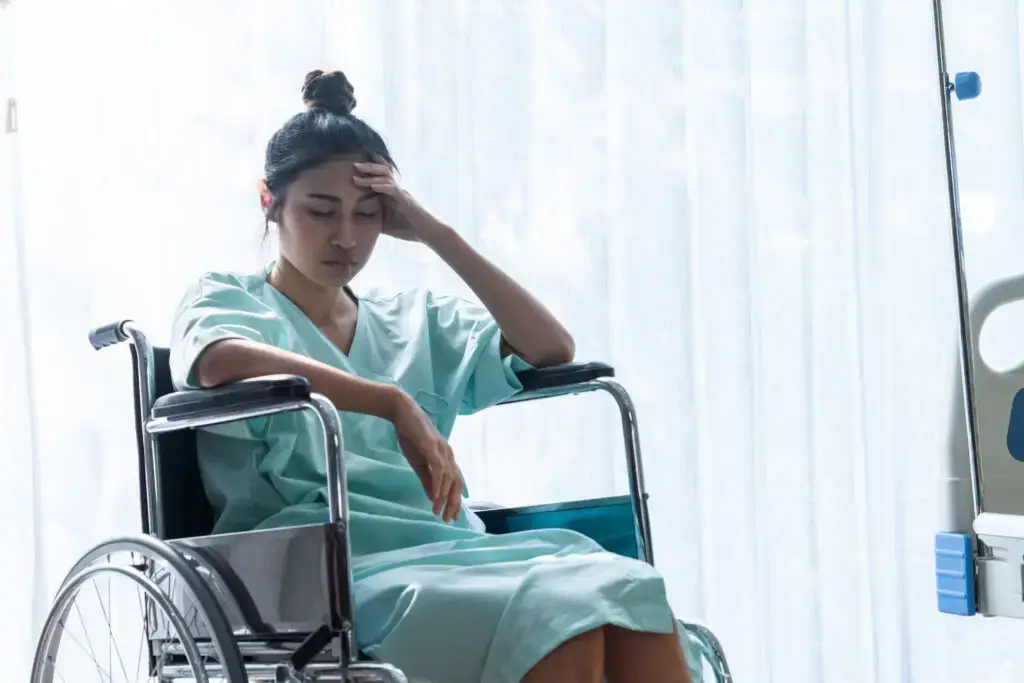 woman at the doctor after an accident in a wheelchair