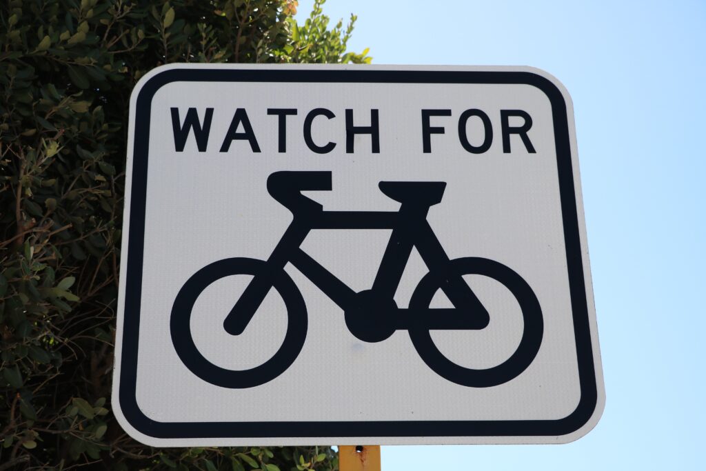 watch for pedestrians biking sign