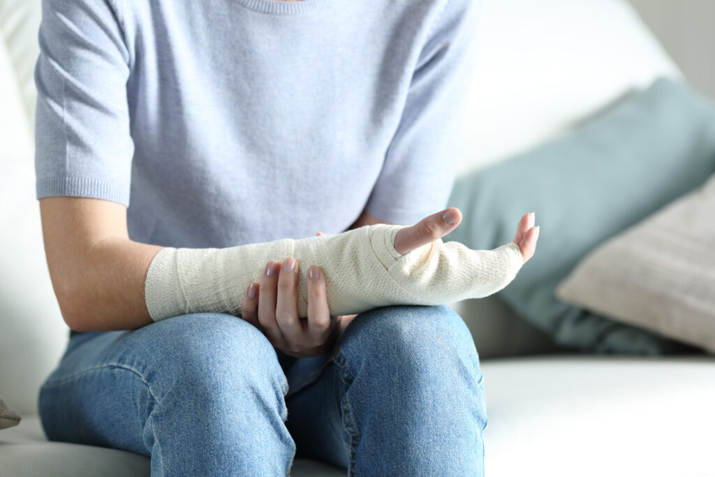 Disabled woman grabbing her painful bandaged arm after a premises liability injury