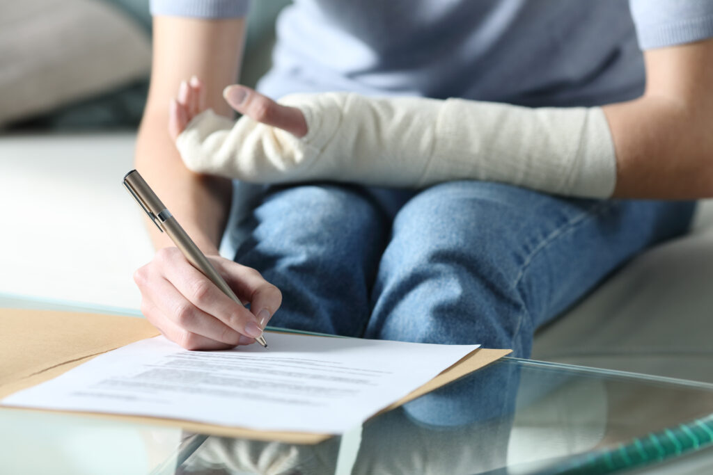 personal injury victim signing a personal injury claim form