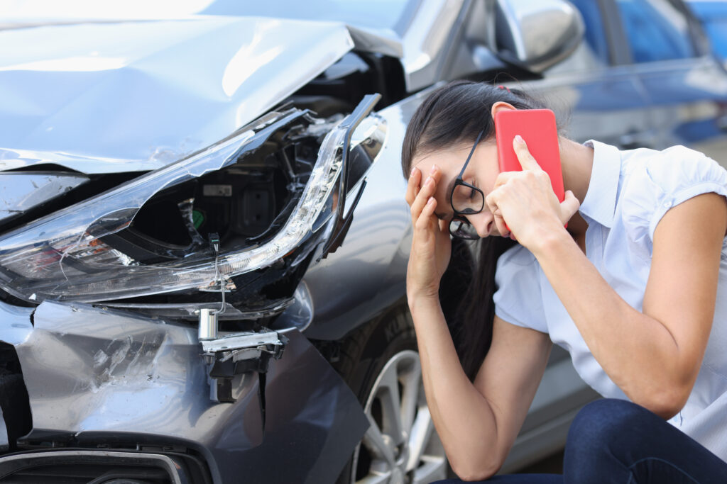 woman on phone after car accident