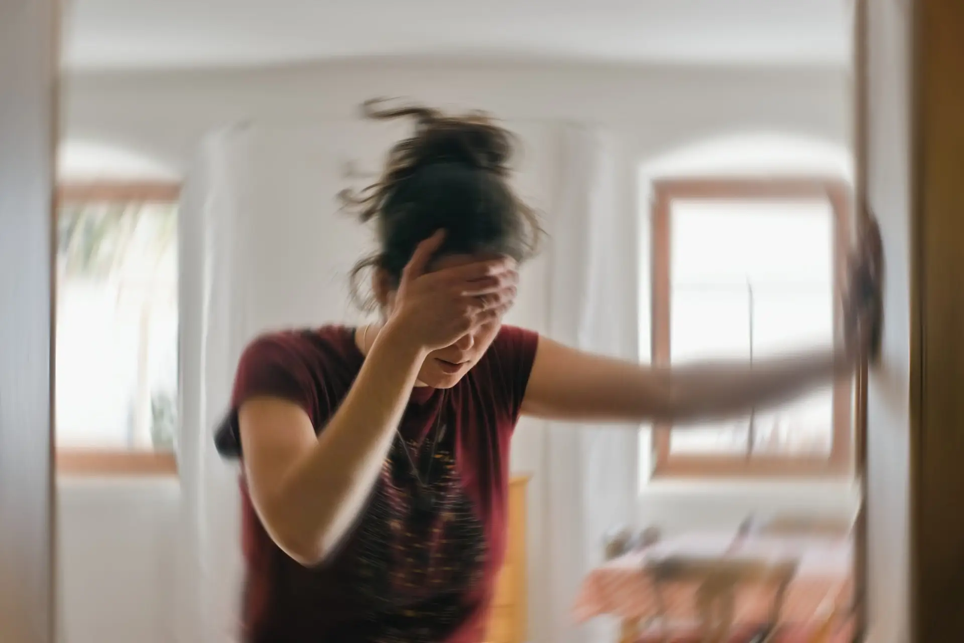 Blurred photo of woman suffering from vertigo or dizziness due to a car accident injury