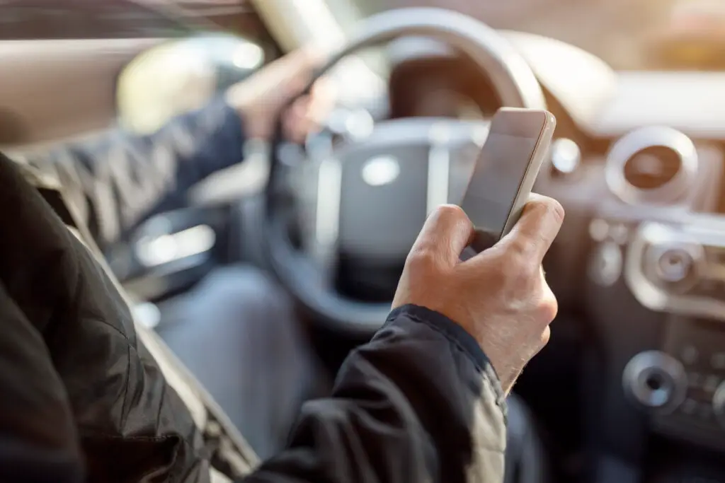 Using a phone in a car texting while driving
