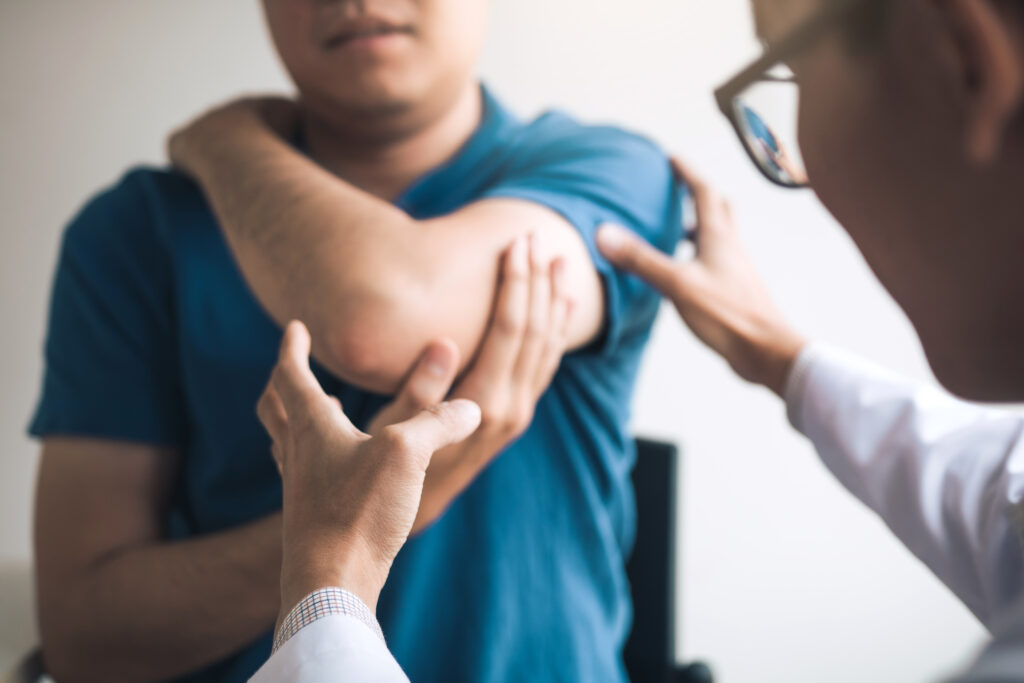 Physical therapists are checking patients elbows at the clinic office room after a personal injury accident