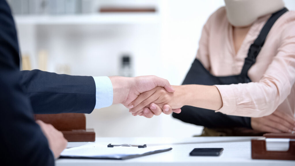 personal injury lawyer shaking clients hand