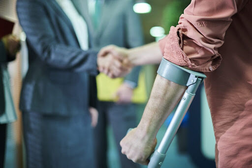 an injured client shakes hands with their uninsured motorist lawyer after a consultation. 