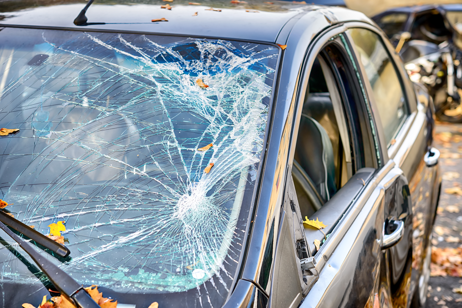 picture of the front windshield of a car shattered after a car accident that caused serious injury