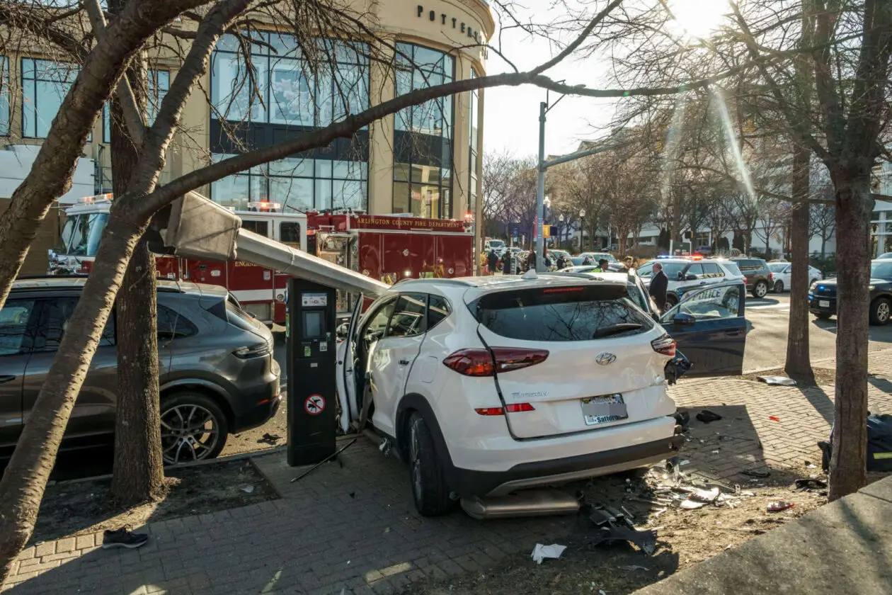 a motor vehicle accident with a damaged automobile on a sidewalk in Virginia.