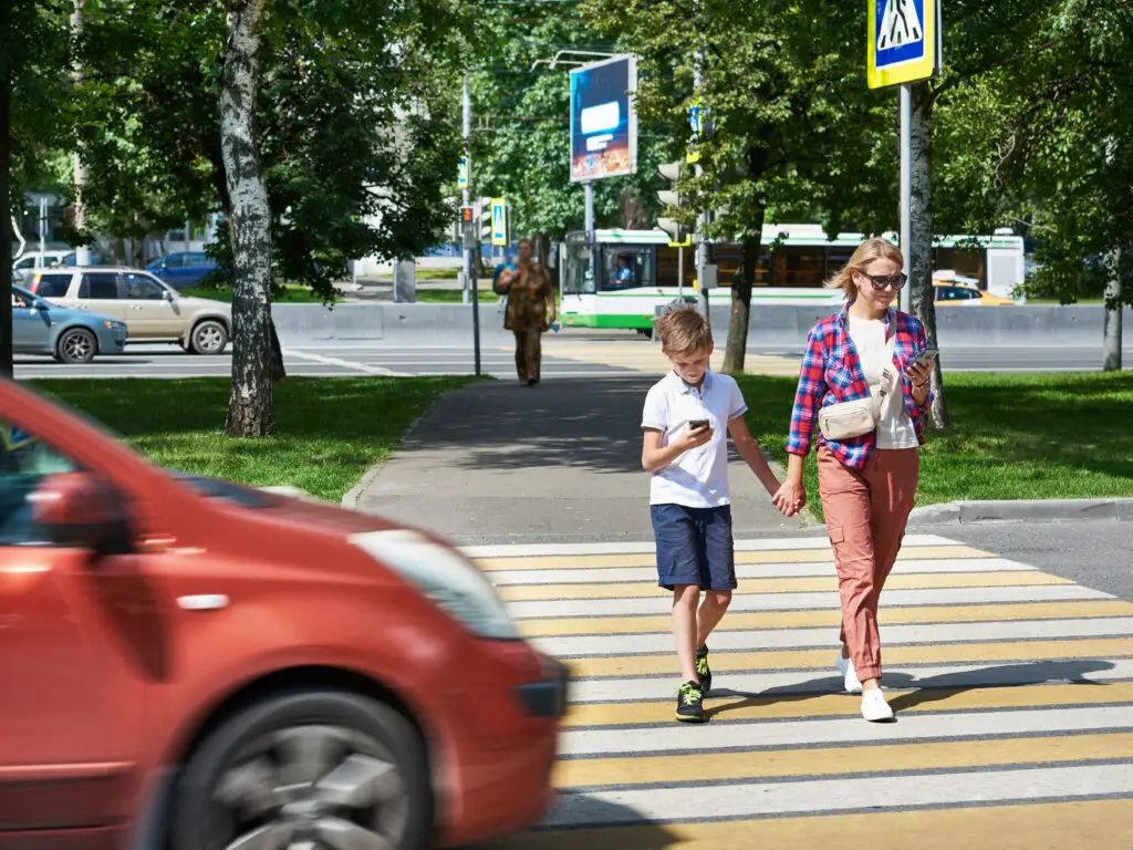 pedestrian accident scene in a crosswalk with mom, son, and car