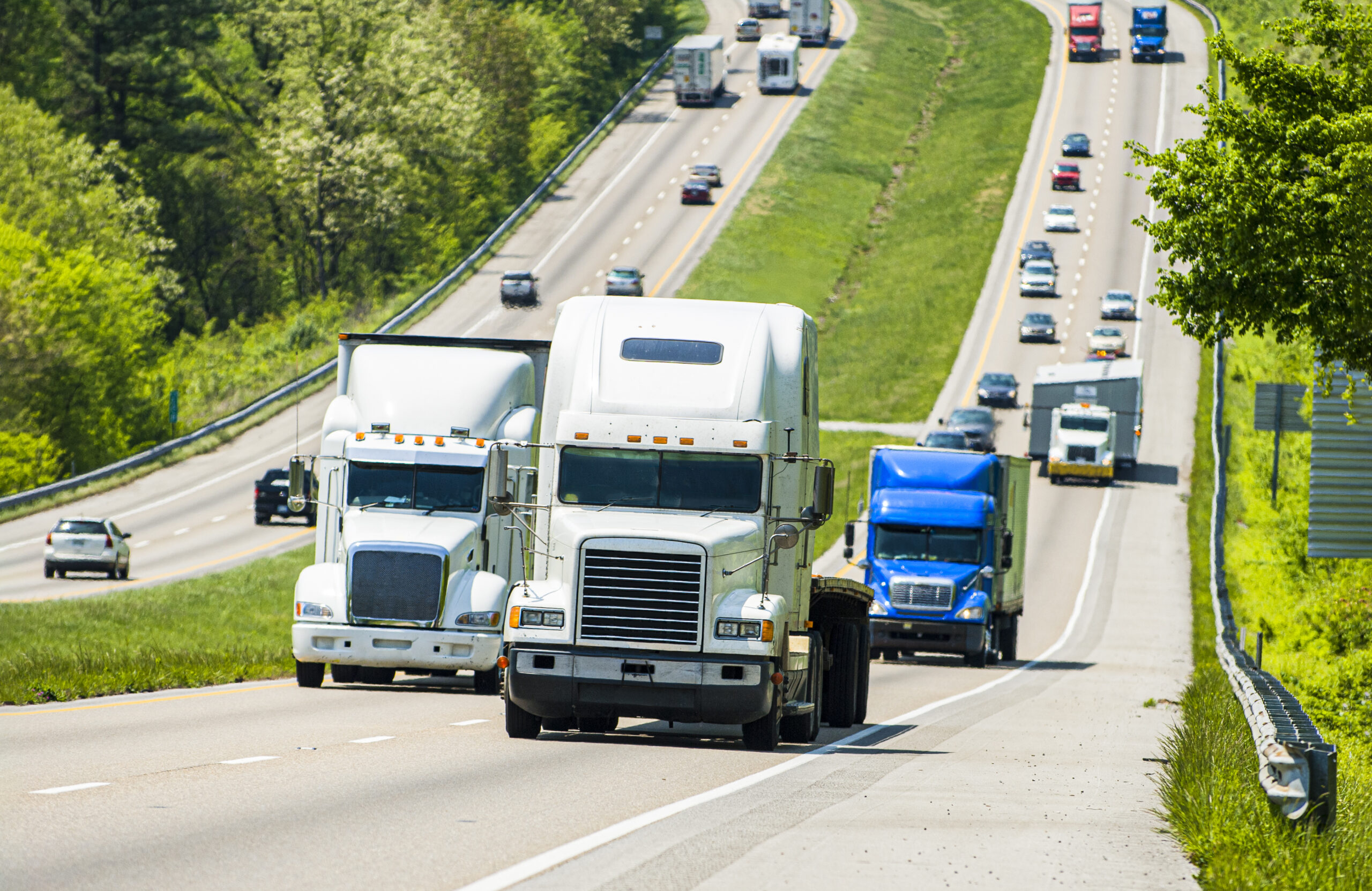 A view of a highway with heavy commercial trucking traffic. 