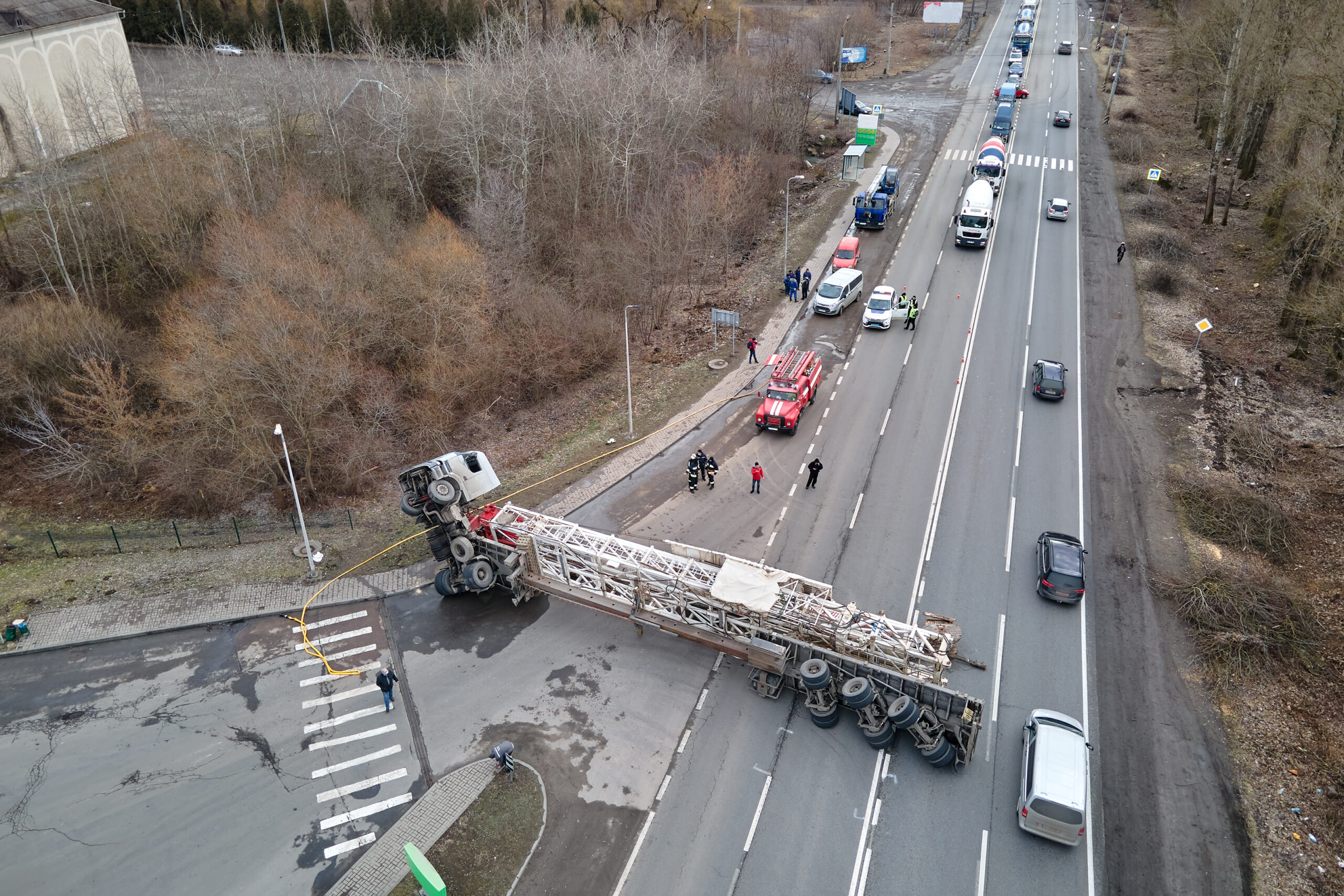 A large transport truck blocks traffic going both ways after rolling onto its side after a jackknife accident.