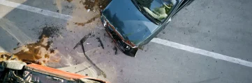 overhead view of a car accident that caused on car to flip onto its roof